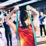 Female coach guiding a member inside a ladies-only gym.
