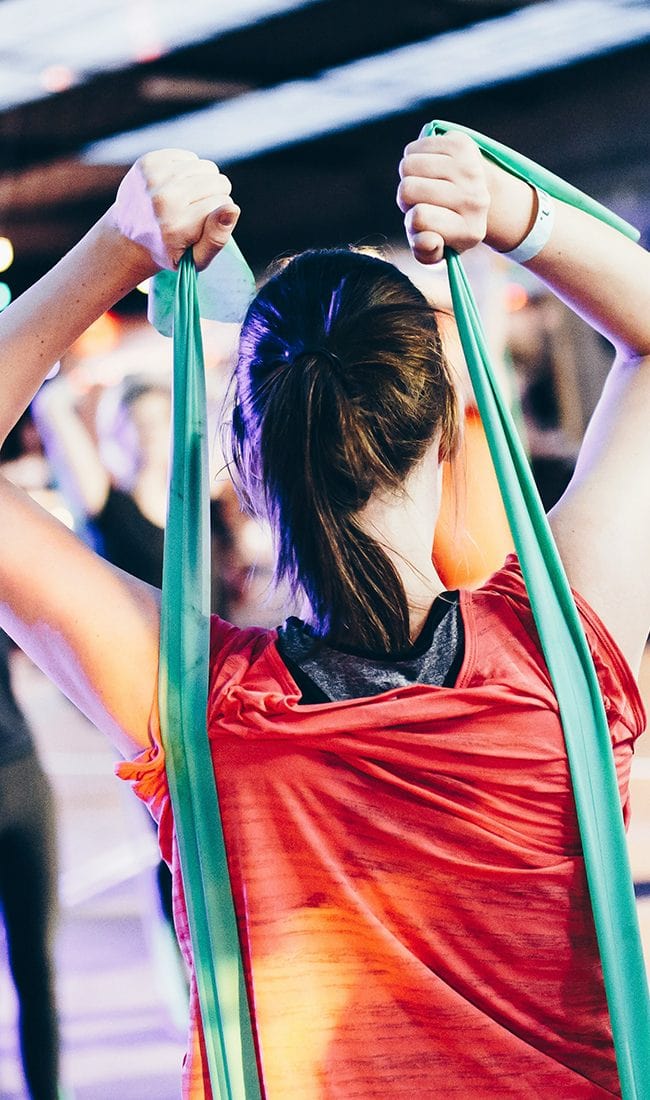 Female coach guiding a member inside a ladies-only gym.