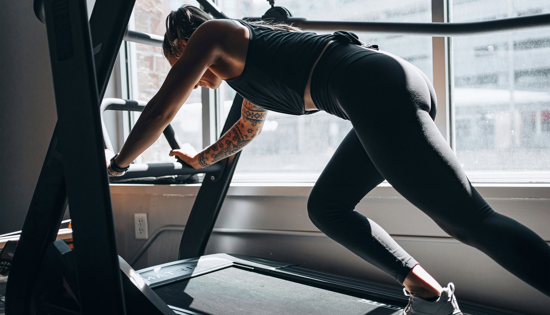 Female athlete using stair stepper for cardio workout