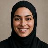 Woman in black hijab smiling in headshot for fitness campaign