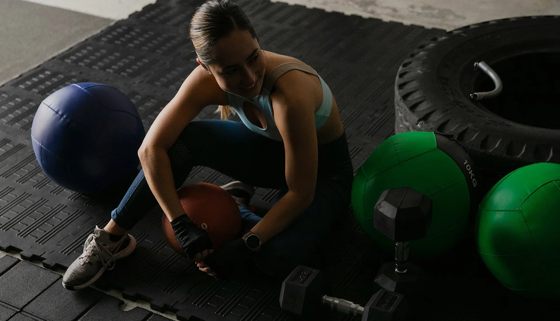 Woman resting after kettlebell workout in gym